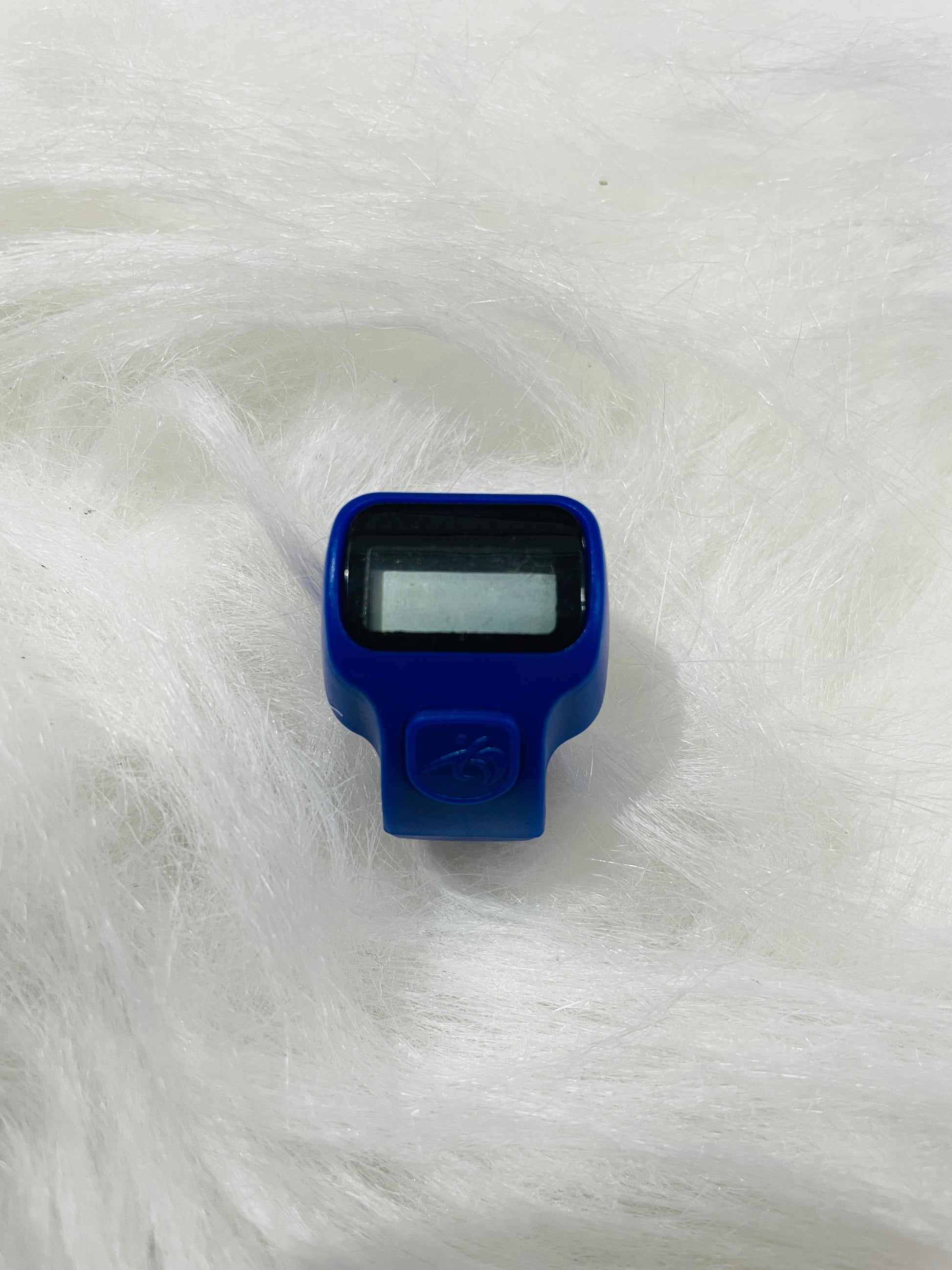 Close-up view of dark blue tasbeeh counter ring showing digital display and button controls